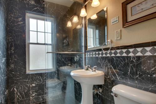 a bathroom with a sink and a toilet and a mirror at Knickerbocker on the Lake in Milwaukee