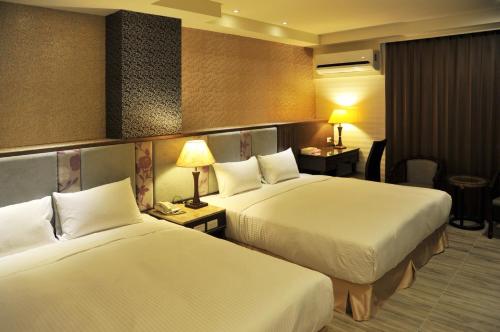 Postel nebo postele na pokoji v ubytování Maple Hotel