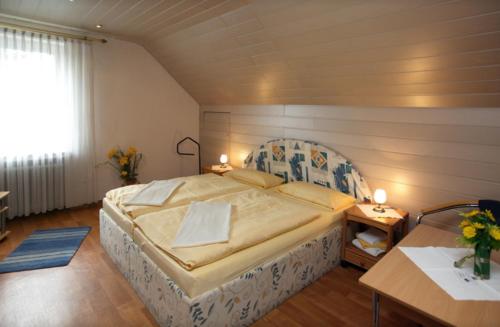 a bedroom with a large bed in a room at Pension Waldau in Kassel