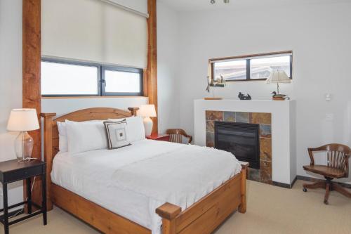 a bedroom with a bed and a fireplace at Black Rock Ridge in Ucluelet