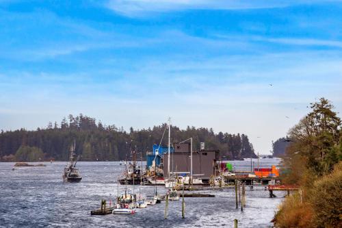 a group of boats docked in a body of water at Black Rock Landing in Ucluelet
