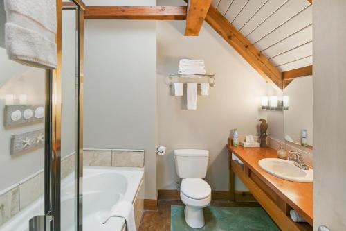 a bathroom with a tub and a toilet and a sink at Black Rock Landing in Ucluelet