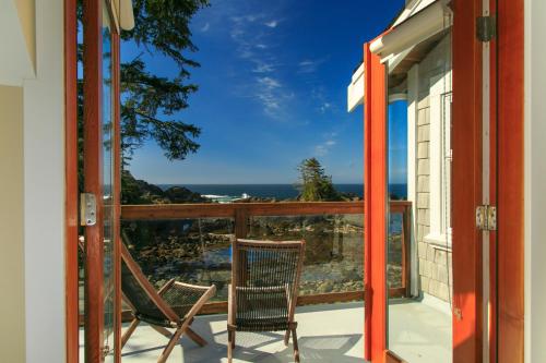 a balcony with chairs and a view of the ocean at Black Rock Beach House in Ucluelet