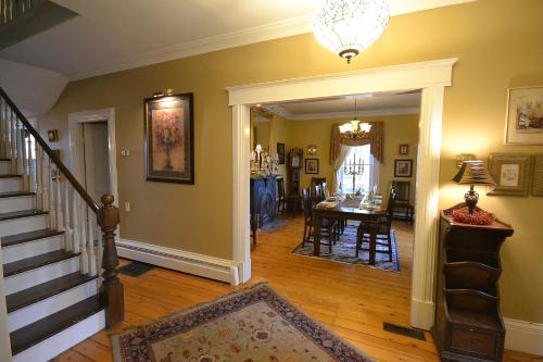 a living room with a staircase and a dining room at Briarwood Bed & Breakfast in Elmsdale
