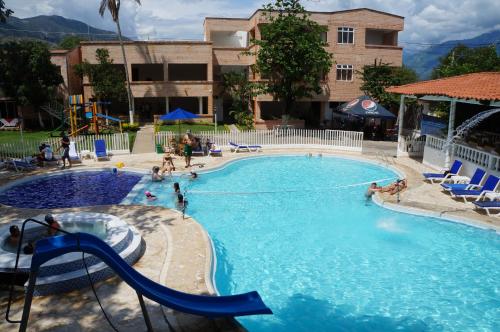 a large swimming pool with a slide in it at Hostería Fundadores in Santa Fe de Antioquia