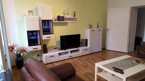 a living room with a couch and a tv at Königstor in Kassel