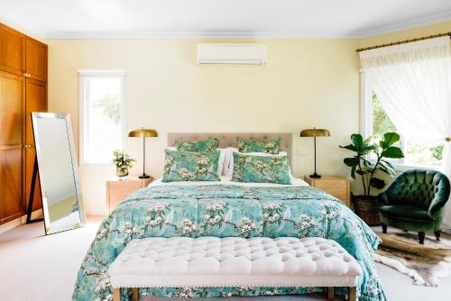 
a bedroom with a large bed and a large window at Beechmont Garden Retreat in Olinda
