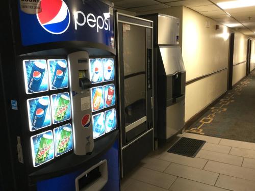 a pepsi machine in a building with a vending machine at Super8 by Wyndham NEARBY Clearwater St Petersburg International Airport in Clearwater