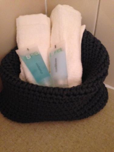 a basket filled with towels and two remote controls at Wudinna Gawler Ranges Motel and Caravan Park in Wudinna