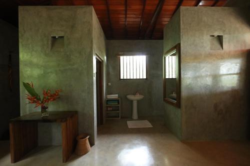 a bathroom with a toilet and a sink at Mangrove Beach Chalets in Tangalle