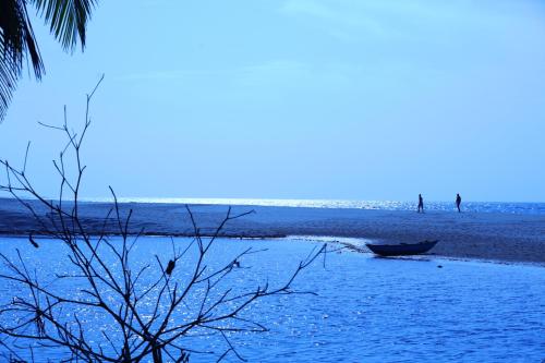 a boat sitting on the shore of a beach at Mangrove Beach Cabana in Tangalle