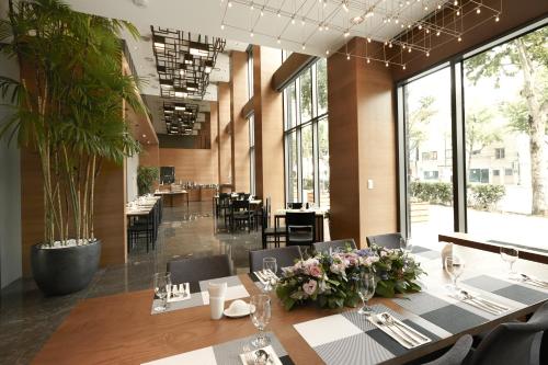 a dining room with a long table and chairs at Mayplace Hotel in Seoul