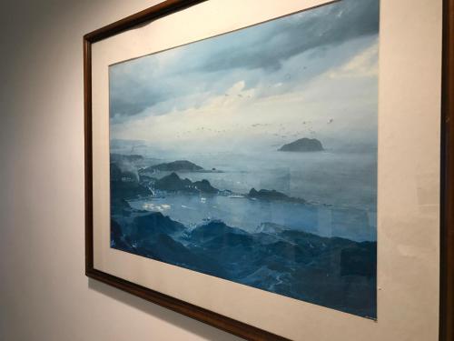 a painting hanging on a wall at Corner Inn九份住宿I 小角落民宿I 機車租借I日夜間導覽 in Jiufen