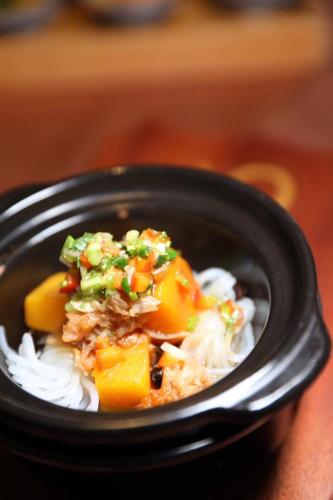 a black bowl of food with rice and vegetables at LN Hotel Five in Guangzhou