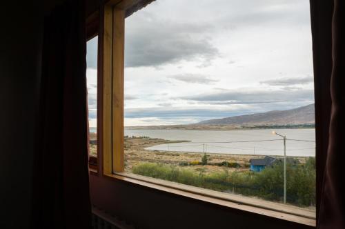 a window with a view of a body of water at Hostería La Soberana in El Calafate