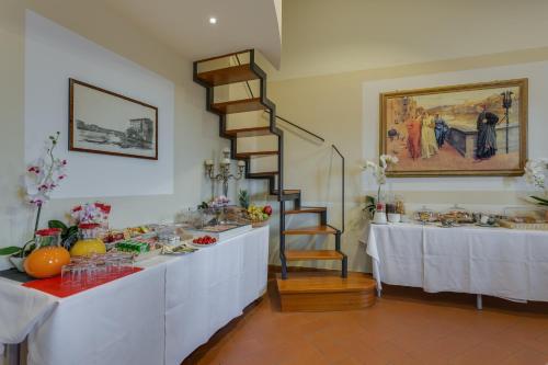 a room with a table and a staircase with food at Locanda Dei Guelfi in Florence