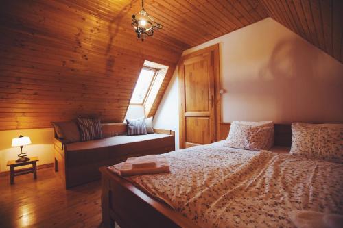 a bedroom with a bed and a couch in a room at Paul's country house | region Donovaly in Horná Turecká