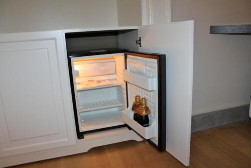 a refrigerator with its door open in a room at Hotel Villa La Colombaia in Portici