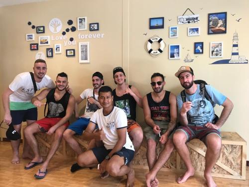 a group of men sitting on a couch at Anya House in Thongsala