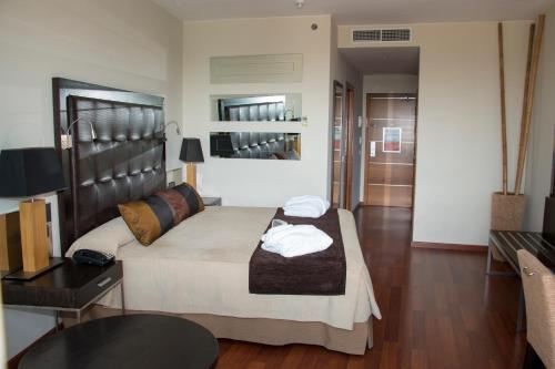 a bedroom with a bed with two towels on it at Senator Banus in Estepona