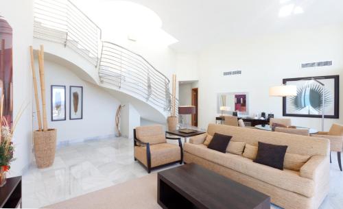a living room with a couch and a table at Senator Banus in Estepona