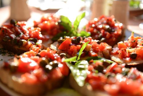 a plate of food with tomatoes and vegetables on it at St. Patrick's Hotel in Xlendi