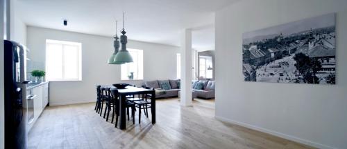 a kitchen and dining room with a table and chairs at Hotel Maribor, City apartments in Maribor