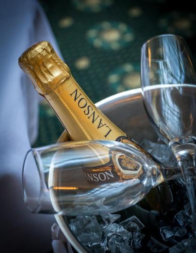 a bottle of wine in a bucket of wine glasses at Old Swan Hotel in Harrogate