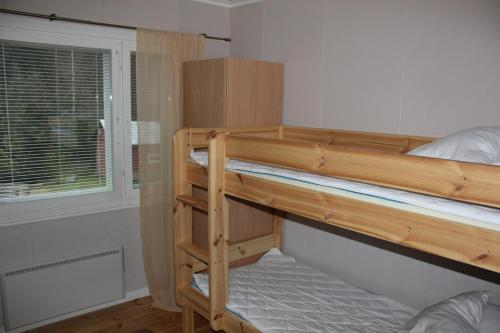 a bedroom with two bunk beds and a window at Päärakennus in Karijoki