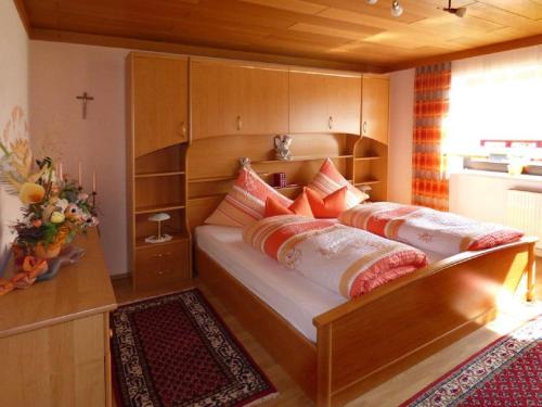 a bedroom with a bed with pillows on it at Landhaus Simon in Gleißenberg
