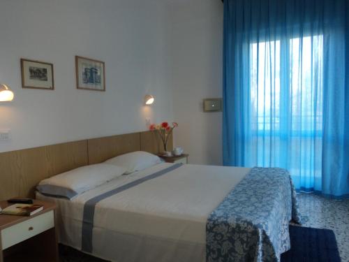 A bed or beds in a room at Hotel Irene