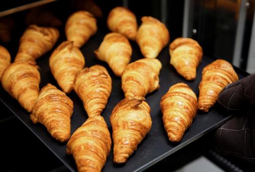 a bunch of croissants sitting on a tray at Candeo Hotels Kobe Tor Road in Kobe