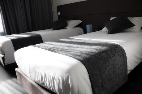 Ένα ή περισσότερα κρεβάτια σε δωμάτιο στο Basto Vila Hotel