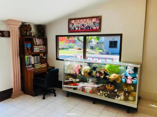 a room with a shelf filled with stuffed animals at Winter House Chiang Rai in Chiang Rai