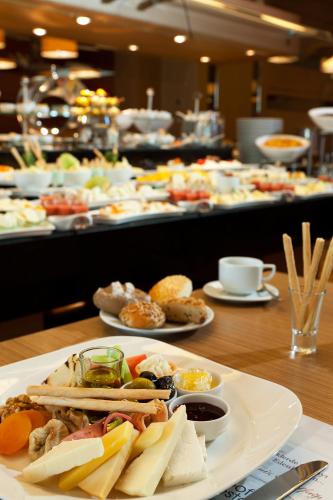 a buffet with plates of food on a table at CPAnkara Hotel in Ankara