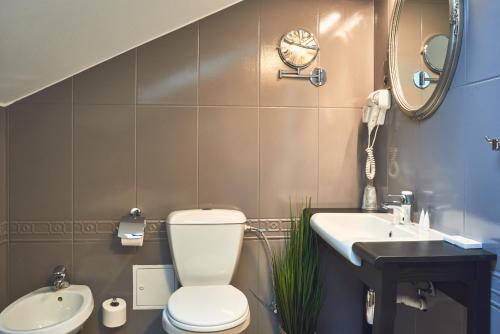 a bathroom with a toilet and a sink at Nobilton Hotel in Krakow