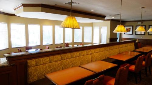 a restaurant with tables and chairs and windows at Extended Stay America Select Suites - Dallas - Richardson in Richardson