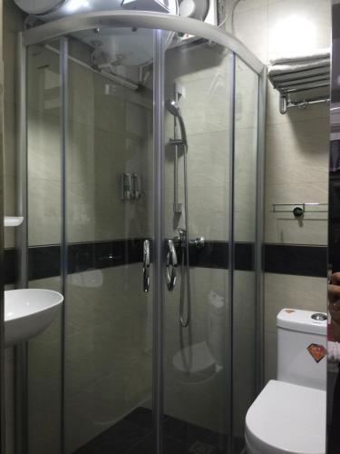 香港的住宿－香港泰山賓館(華敦大廈)，一间带卫生间的浴室内的玻璃淋浴间