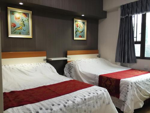 Ein Bett oder Betten in einem Zimmer der Unterkunft Hong Kong Tai San Guest House (Burlington Branch)