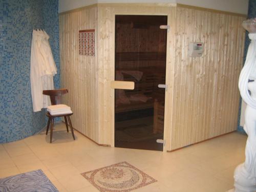 a room with a door and a chair in it at Alpengasthof Eichtbauer in Spital am Semmering