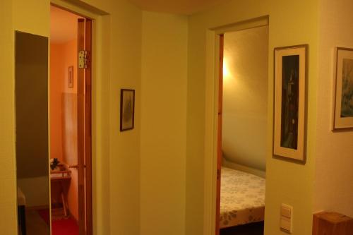 a hallway with a door leading to a bedroom at Viesu māja Forrest in Dzimtmisa