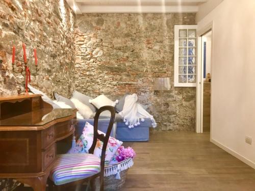 a room with a piano and a blue couch at Il Giardino Segreto Arona, Charming Apartments in Arona