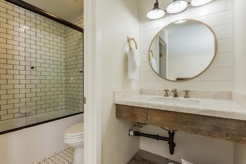 a bathroom with a sink and a mirror and a toilet at Crestview 35 in Mammoth Lakes