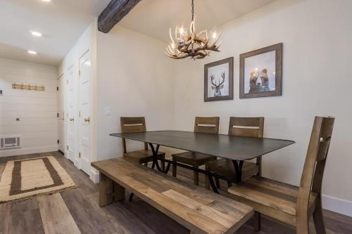 a dining room with a table and chairs and a chandelier at Crestview 35 in Mammoth Lakes