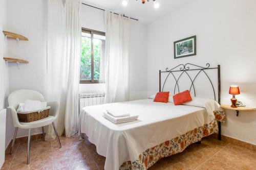 a bedroom with a bed with red pillows on it at aMatalasviñas in Piedralaves