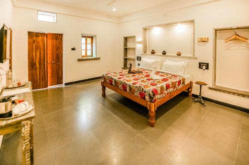 a bedroom with a bed and a large mirror at The Neem Tree in Udaipur