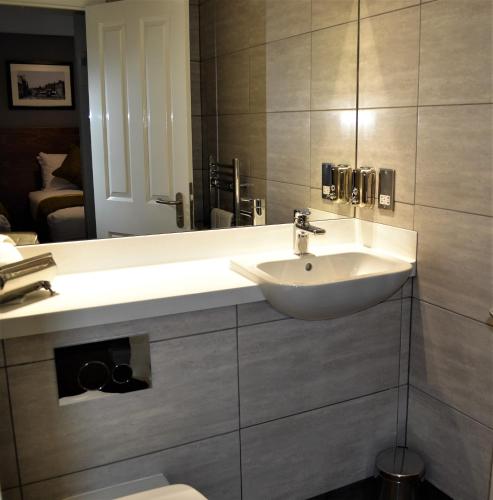 a bathroom with a sink and a toilet at New Park Hotel in Carmarthen