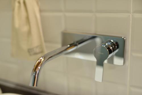 a shower head hooked up to a faucet in a bathroom at Rock&Wood Cozy House in Hangzhou