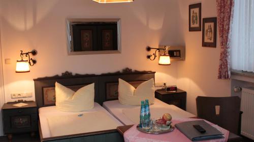 a bedroom with a bed and a table with a plate on it at Haus Florian in Grainau
