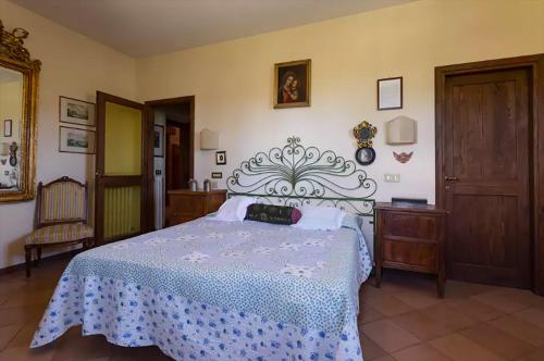 a bedroom with a bed with a blue and white bedspread at Private pool Villa Wine&cooking -Trasimeno Lake in Panicale